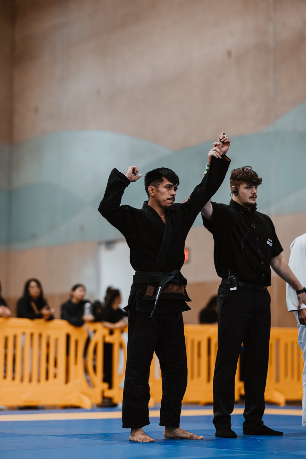 Black belt competitor winning his match at a Jiu-Jitsu tournament