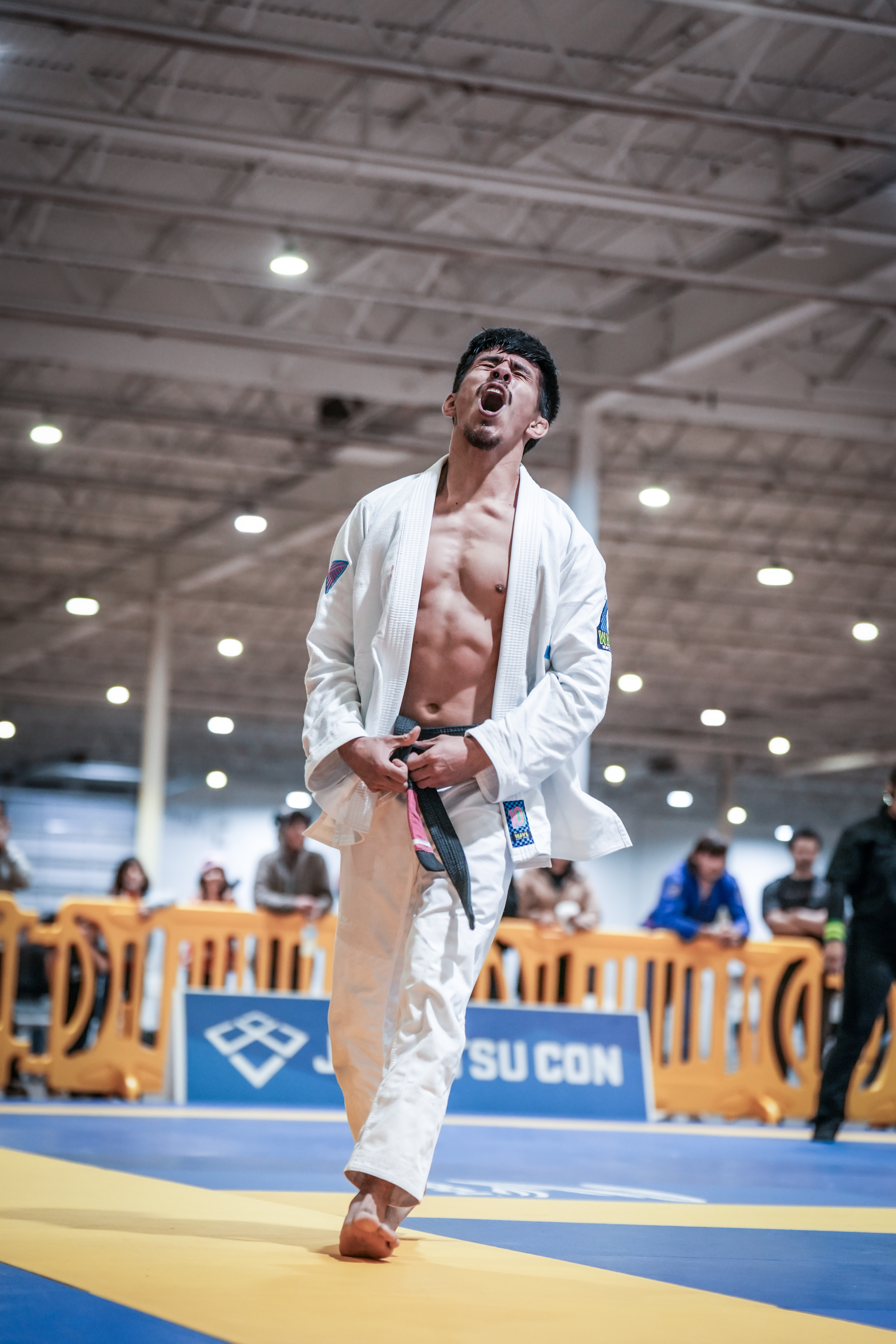 Vasquez Jiu-Jitsu competitor celebrating a tournament win in his gi